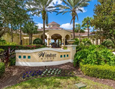a house with a sign in front of a yard at Beautiful Condo - Windsor Hills - 2 Miles Disney in Orlando