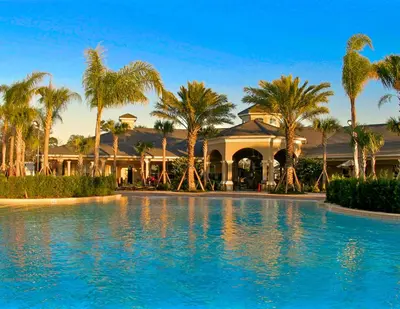 a resort with palm trees and a swimming pool at Ground Floor at Windsor Hills – 5 Min Disney in Orlando