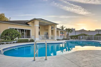 a swimming pool in front of a house at Kissimmee Condo with Resort Perks - 5 Mi to Disney! in Orlando
