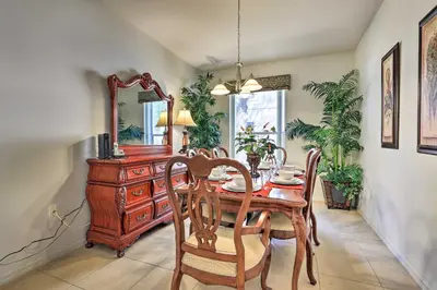 a dining room with a table and chairs and a mirror at Kissimmee Condo with Resort Perks - 5 Mi to Disney! in Orlando