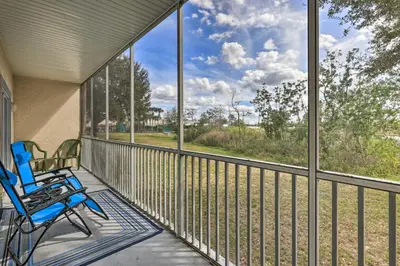 a screened porch with chairs and a view of a field at Kissimmee Condo with Resort Perks - 5 Mi to Disney! in Orlando