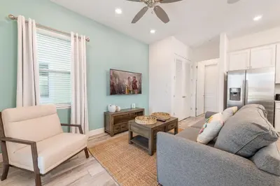 a living room with a couch and a chair at The Tiki Room - Beautiful Two Bedroom Cottage Near Disney With Margaritaville Resort & Island H20 Waterpark Access - 2954Sr in Orlando