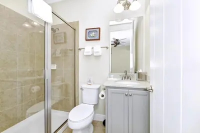 a bathroom with a toilet and a sink and a shower at Seas The Day Cottage Near Disney With Margaritaville Resort & Island H2O Access - 8001Ff in Orlando