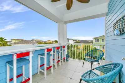 a balcony with chairs and a bar with a view at Seas The Day Cottage Near Disney With Margaritaville Resort & Island H2O Access - 8001Ff in Orlando