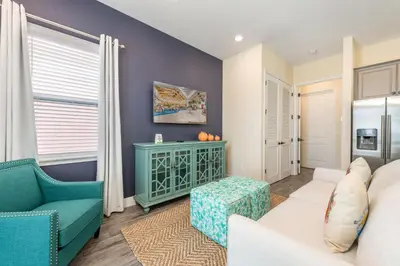 a living room with a couch and a chair at Tropical Paradise Cottage Near Disney With Margaritaville Resort & Island H2O Access - 8061Kd in Orlando