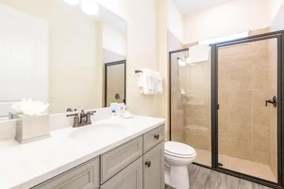 a bathroom with a toilet and a sink and a shower at Tropical Paradise Cottage Near Disney With Margaritaville Resort & Island H2O Access - 8061Kd in Orlando