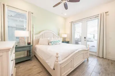 a white bedroom with a bed and a window at Life Is Good Cottage Near Disney With Margaritaville Resort & Island H2O Access - 8059Kd in Orlando