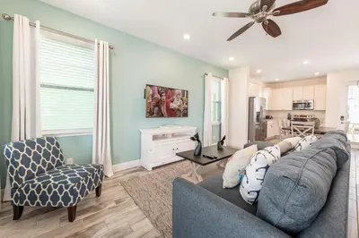 a living room with a couch and a ceiling fan at The Island Life! Near Disney With Margaritaville Resort & Island H2O Access - 8055Kd in Orlando