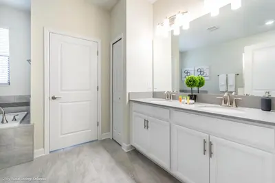 a bathroom with two sinks and a large mirror at 2911 Fable Street in Kissimmee