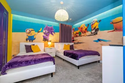 a bedroom with two beds and a mural of a beach at 2911 Fable Street in Kissimmee