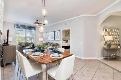 a dining room and living room with a table and chairs at Beautiful Vista Cay Condo, Near I-Drive in Orlando