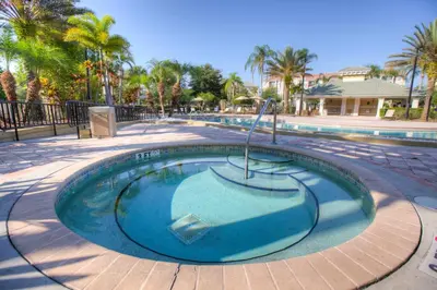 a small swimming pool in a resort with palm trees at Breakview Fun & Sun in Orlando