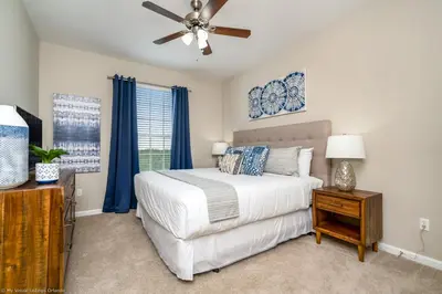 a bedroom with a bed and a ceiling fan at Breakview Fun & Sun in Orlando