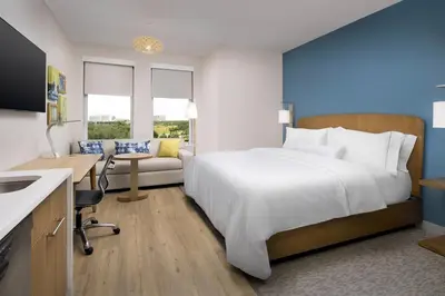a hotel room with a large bed and a desk at Element Orlando Universal Blvd. in Orlando