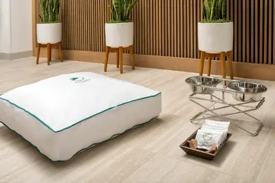 a bed and two tables in a room with plants at Element Orlando Universal Blvd. in Orlando