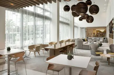 a restaurant with tables and chairs and windows at Element Orlando Universal Blvd. in Orlando