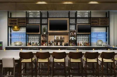 a bar in a hotel with chairs and a counter at Hilton Garden Inn Apopka City Center, Fl in Orlando