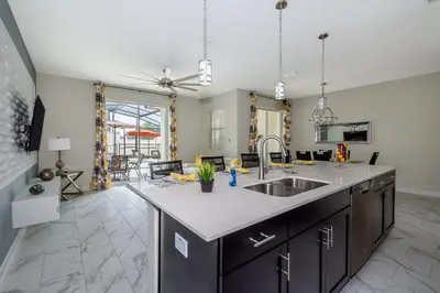 a kitchen with a sink and a counter top at 4929GC TOWNHOUSE 4 BEDROOMS & 3 BATHROOMS + POOL in Kissimmee