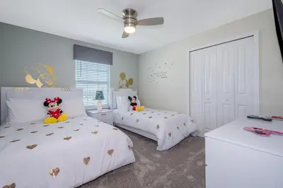 a bedroom with two beds with stuffed animals on them at 4975AN TOWNHOUSE 5 BEDROOMS & 4 BATHROOMS + POOL in Kissimmee