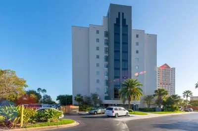 a large building with cars parked in a parking lot at Deluxe Studio w/ Lakeview - free parking/pool in Orlando