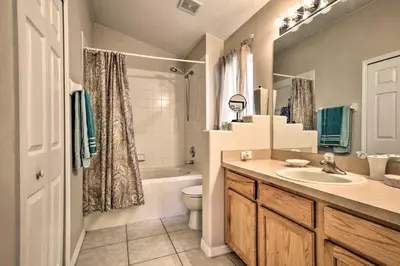 a bathroom with a sink and a tub and a toilet at Family Home with Game Room 9 Mi to Disney World in Orlando