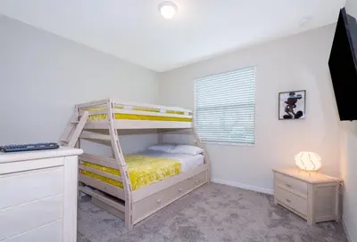 a bedroom with a bunk bed with a ladder at 4721-101FG STOREY LAKE, CONDO 3/2 GARDEN VIEW in Kissimmee