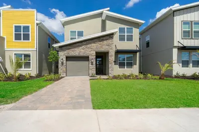 a large house with a driveway in front of it at 2770AG VILLA 5 BED/5 BA (SANITIZED) in Kissimmee