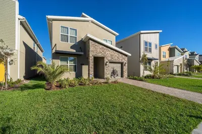 a house with a lawn in front of it at 2738WE VILLA 5 BED/5 BA (SANITIZED) in Kissimmee