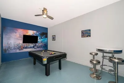 a room with a pool table and a flat screen tv at 2738WE VILLA 5 BED/5 BA (SANITIZED) in Kissimmee