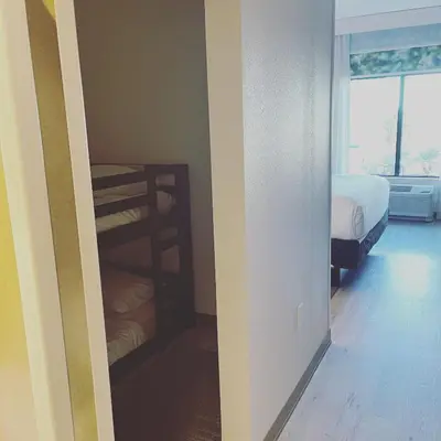 a room with two bunk beds and a window at Wyndham Garden Orlando Universal / I Drive in Orlando