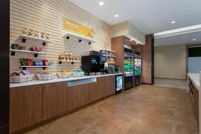 a lobby of a store with a cashierasteryasteryasteryasteryasteryasteryastery at Wyndham Garden Orlando Universal / I Drive in Orlando