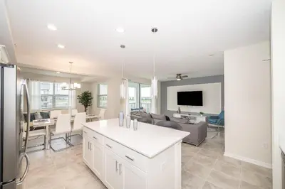 a kitchen and living room with a couch and a table at 3120-206DR STOREY LAKE, CONDO 2/2 GARDEN VIEW in Kissimmee