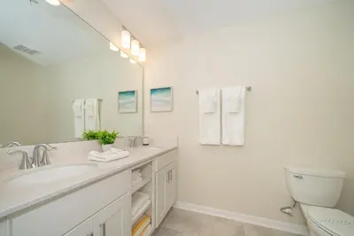 a white bathroom with a sink and a toilet at 3120-206DR STOREY LAKE, CONDO 2/2 GARDEN VIEW in Kissimmee