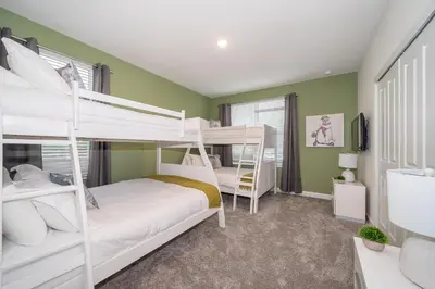 two bunk beds in a room with green walls at 2731EE VILLA 5 BED/5 BA (SANITIZED) in Kissimmee