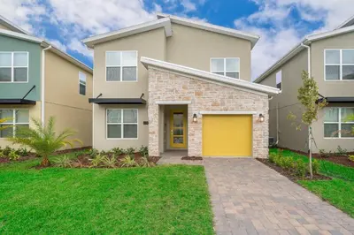 a house with a yellow garage at 2744HM VILLA 5 BED/5 BA (SANITIZED) in Kissimmee