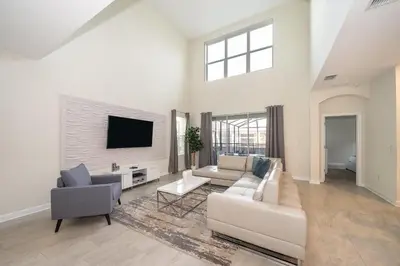 a living room with a couch and a tv at 2744HM VILLA 5 BED/5 BA (SANITIZED) in Kissimmee