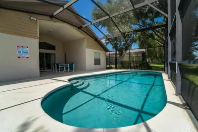 a swimming pool in the backyard of a house at 16150EGRET- Sun Chaser (S) in Orlando