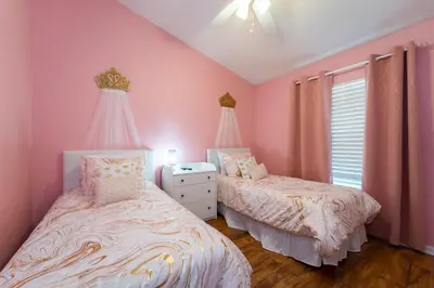 two beds in a bedroom with pink walls at 16150EGRET- Sun Chaser (S) in Orlando