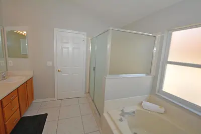 a bathroom with a tub and a sink at 2685OL - Jagu Deaux (G) in Kissimmee