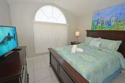 a bedroom with a bed and a flat screen tv at 2685OL - Jagu Deaux (G) in Kissimmee