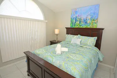 a bedroom with a bed with two candles on it at 2685OL - Jagu Deaux (G) in Kissimmee