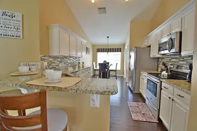 a kitchen with white cabinets and a counter top at 4639EPD - Comfort Island (G) in Kissimmee