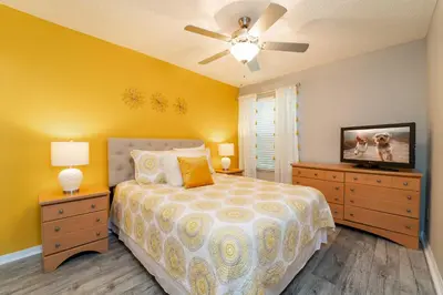 a bedroom with a bed with a ceiling fan and a tv at VOS-2739PB-73 - Somerset Gardens (S) in Kissimmee
