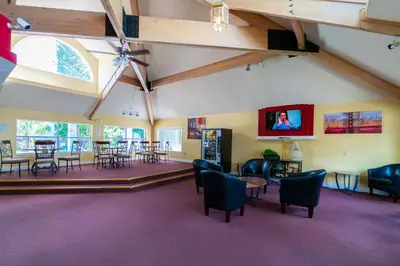 a large room with chairs and tables and a tv at VOS-2739PB-73 - Somerset Gardens (S) in Kissimmee