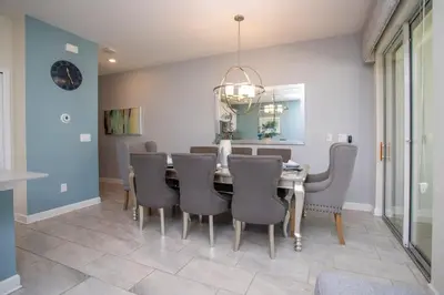 a dining room with a table and chairs at Ravishing Four Bd w/ Pool Close to Disney 4947 in Kissimmee