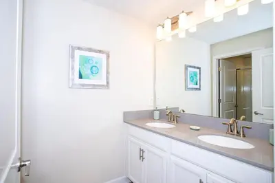 a bathroom with two sinks and a large mirror at Ravishing Four Bd w/ Pool Close to Disney 4947 in Kissimmee