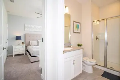 a bathroom with a sink and a toilet and a bed at Ravishing Four Bd w/ Pool Close to Disney 4947 in Kissimmee