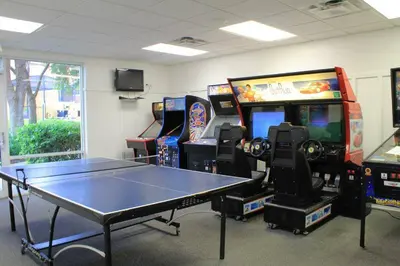 a room with a ping pong table and arcade games at Encantada 3 Bedroom Townhome with Pool 2009 in Kissimmee