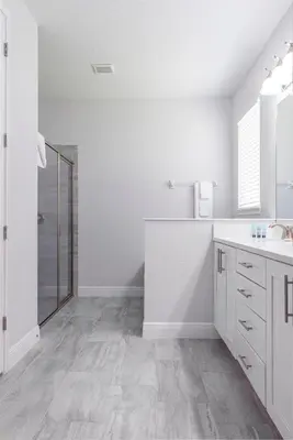 a white bathroom with a sink and a shower at Upscale Modern Getaway home with heated pool/hot tub, 9 beds 8.5 bath Sleeps 18+ in Orlando