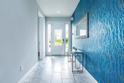 a hallway with a blue wall with fish painted on it at Upscale Modern Getaway home with heated pool/hot tub, 9 beds 8.5 bath Sleeps 18+ in Orlando